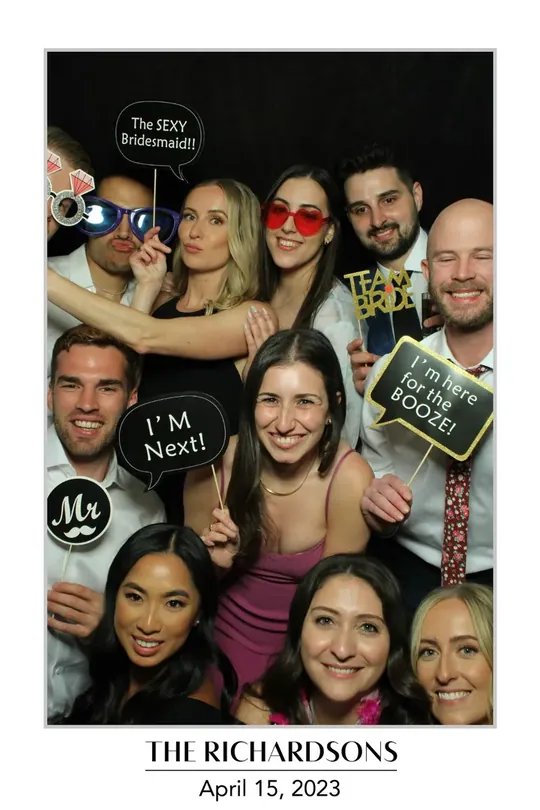 Large group of guests with I’m Next props at a Dundas wedding photo booth, Hamilton