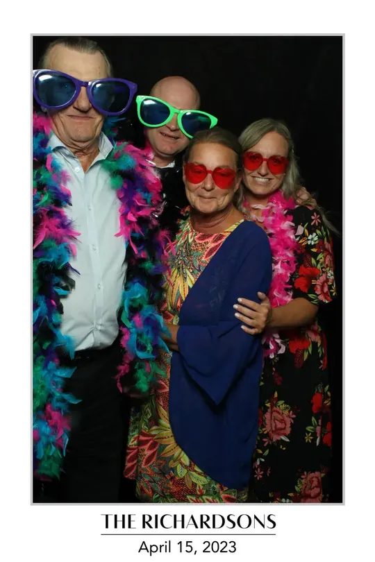 Guests in feather boas and giant sunglasses at a Dundas wedding photo booth