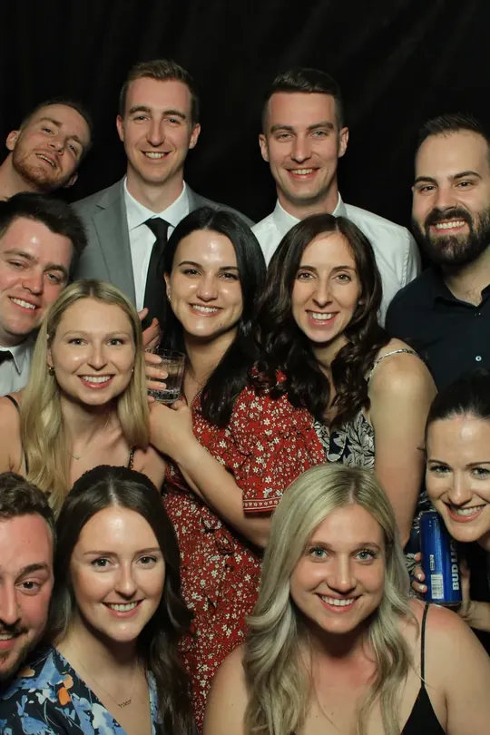 Crowd of smiling guests packed into a Dundas wedding photo booth