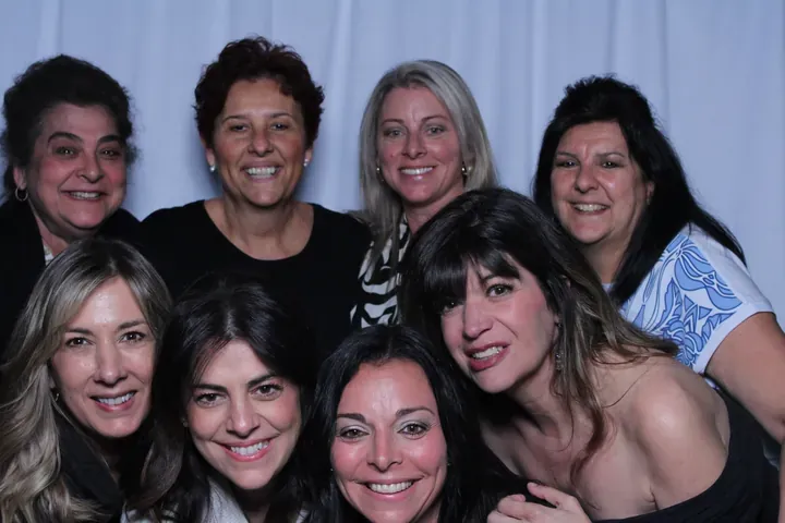 Eight women crowded into the photo booth at a Niagara Falls wedding