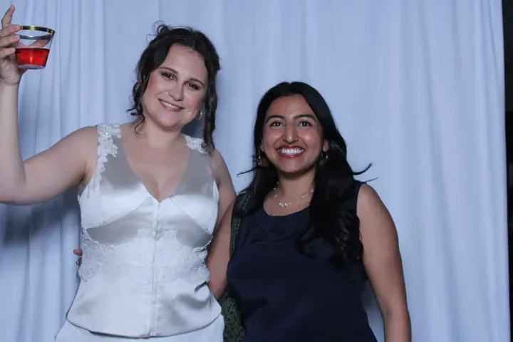 Two guests raising a glass at a Niagara Falls wedding photo booth
