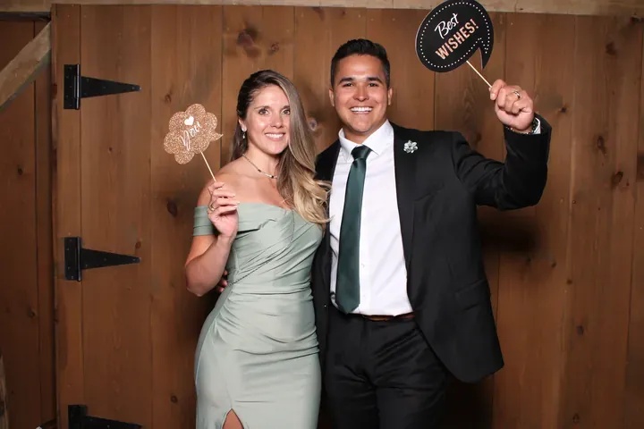Couple holding a prop sign at a Maple Meadows wedding photo booth in Port Colborne