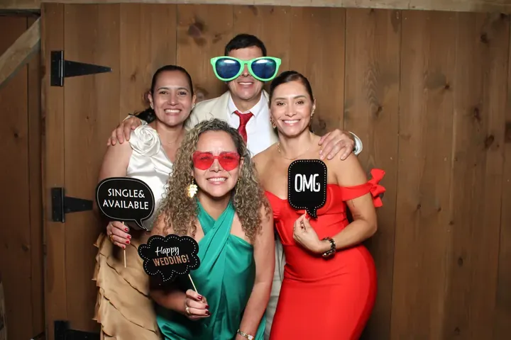 Wedding guests with OMG and Single and Available signs at a Port Colborne photo booth