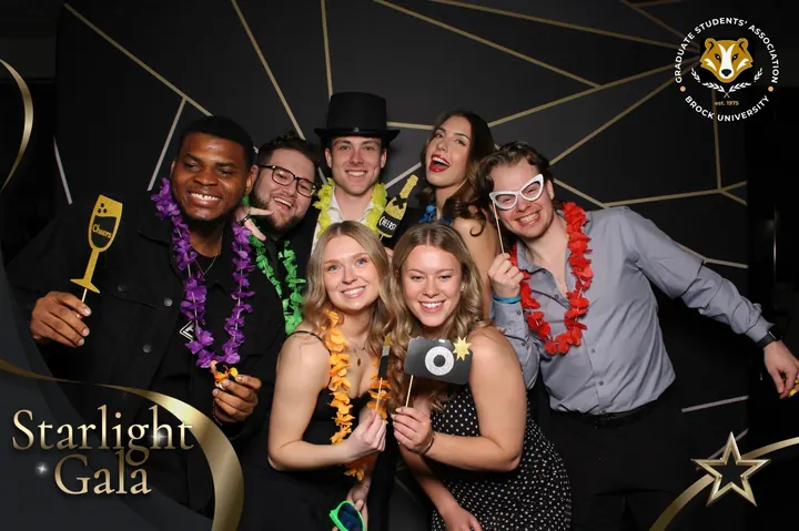 Seven guests in leis with Cheers props at the photo booth, Starlight Gala, St. Catharines