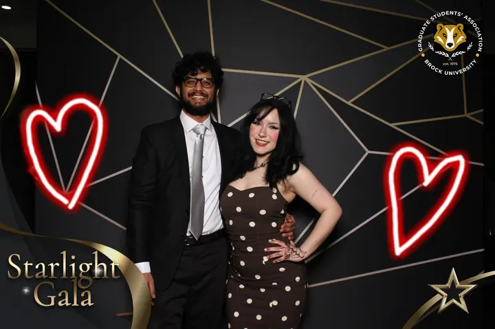 Couple with neon heart overlays at the Starlight Gala photo booth in St. Catharines