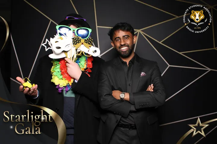 Gala guest hiding behind a handful of props at a St. Catharines photo booth