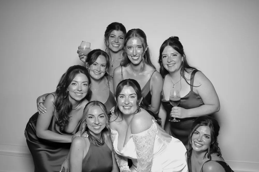 Bride with her bridesmaids at the photo booth, black and white