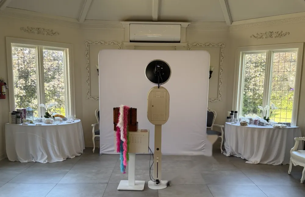 Self-serve photo booth with a white backdrop and prop station at Lincoln Estates in Lincoln
