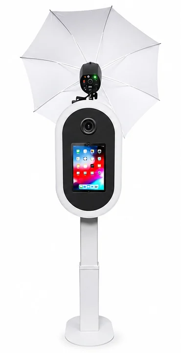 The self-serve photo booth: camera and touchscreen head, umbrella flash, on a slim pedestal stand